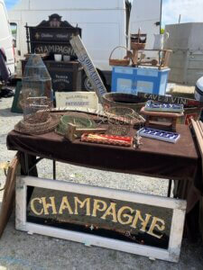 Brocante stall in SW France with wire egg baskets and signs